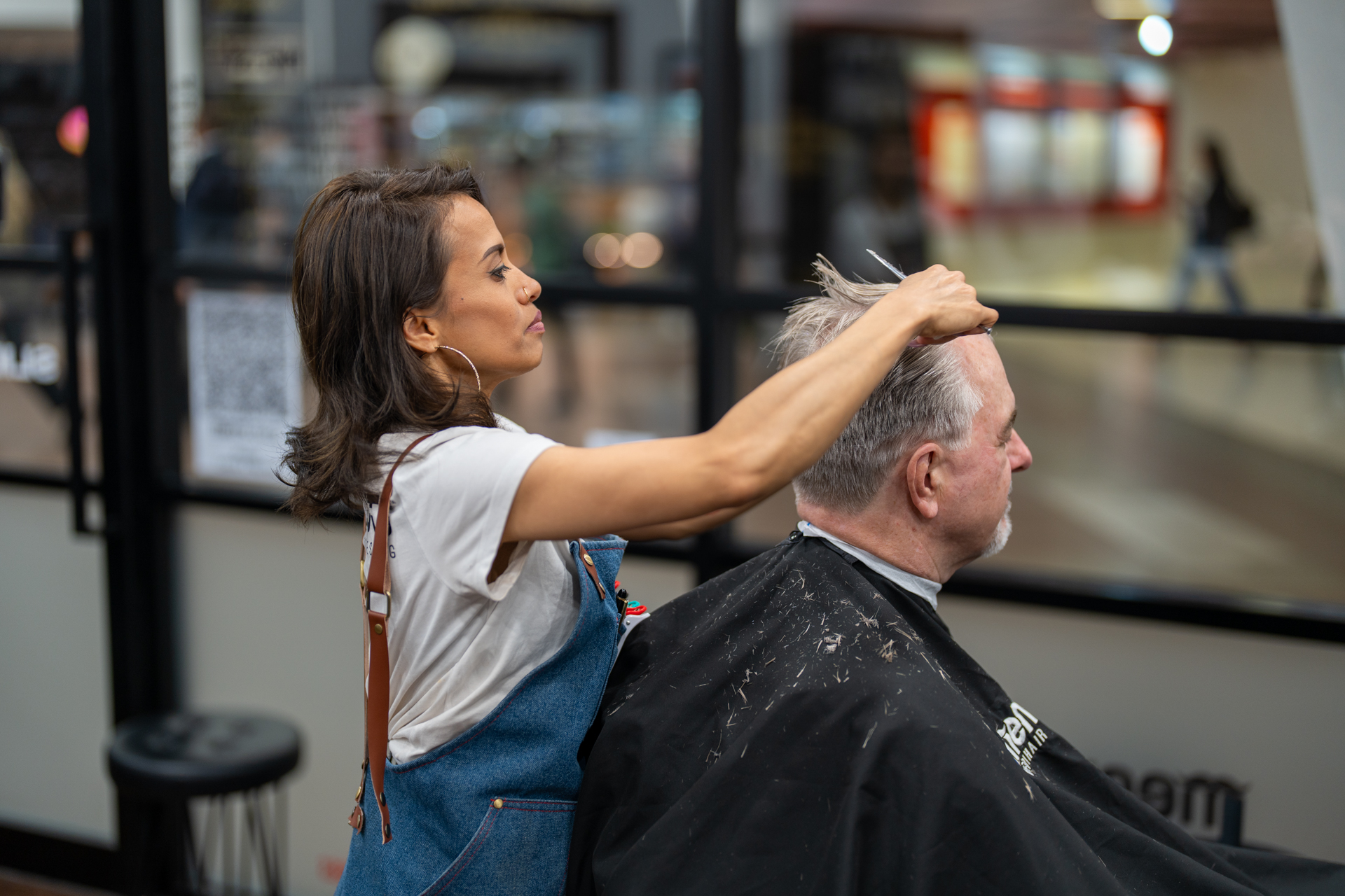 Female Barber Cutting Client's Hair